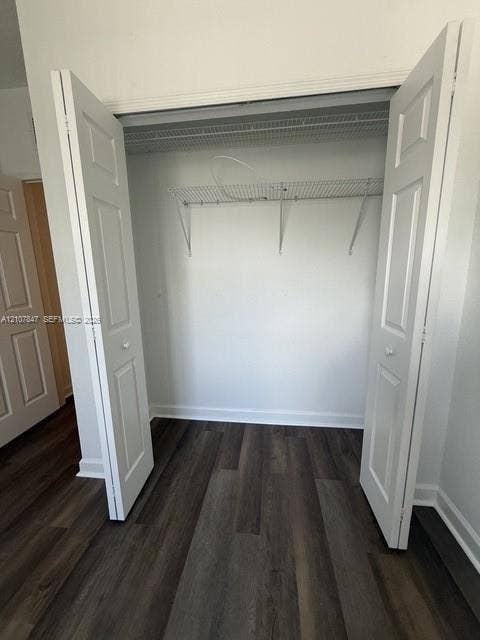 Reach-in closet featuring white bifold doors and dual-tier wire shelving