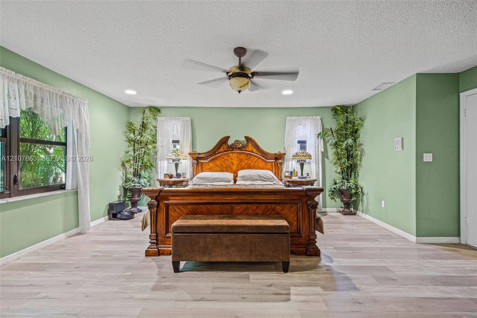 Room with wood-finish flooring, recessed lighting, and a ceiling-mounted fan with integrated light fixture