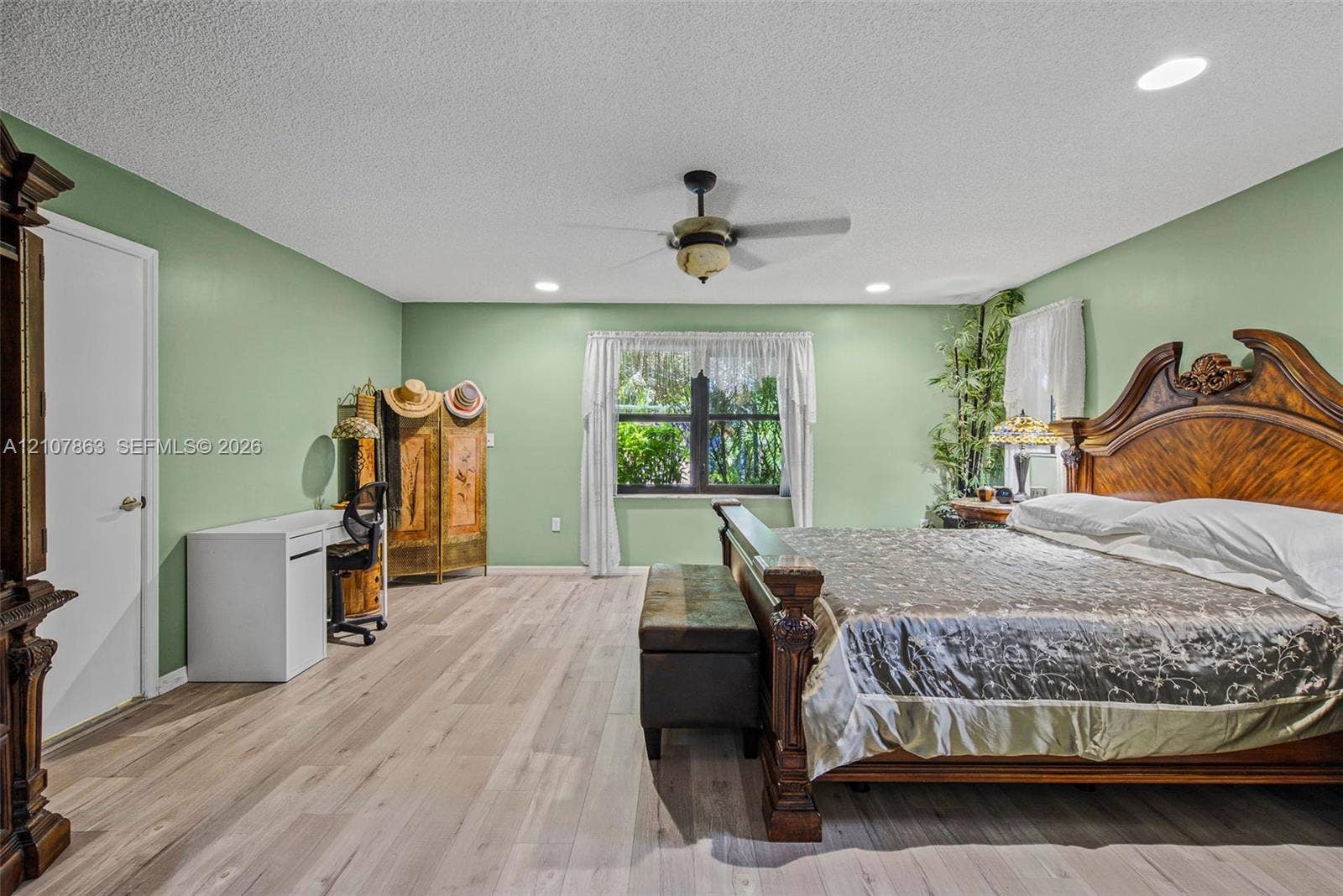 Spacious interior featuring wood-finish flooring, recessed lighting, and a centrally located ceiling fan