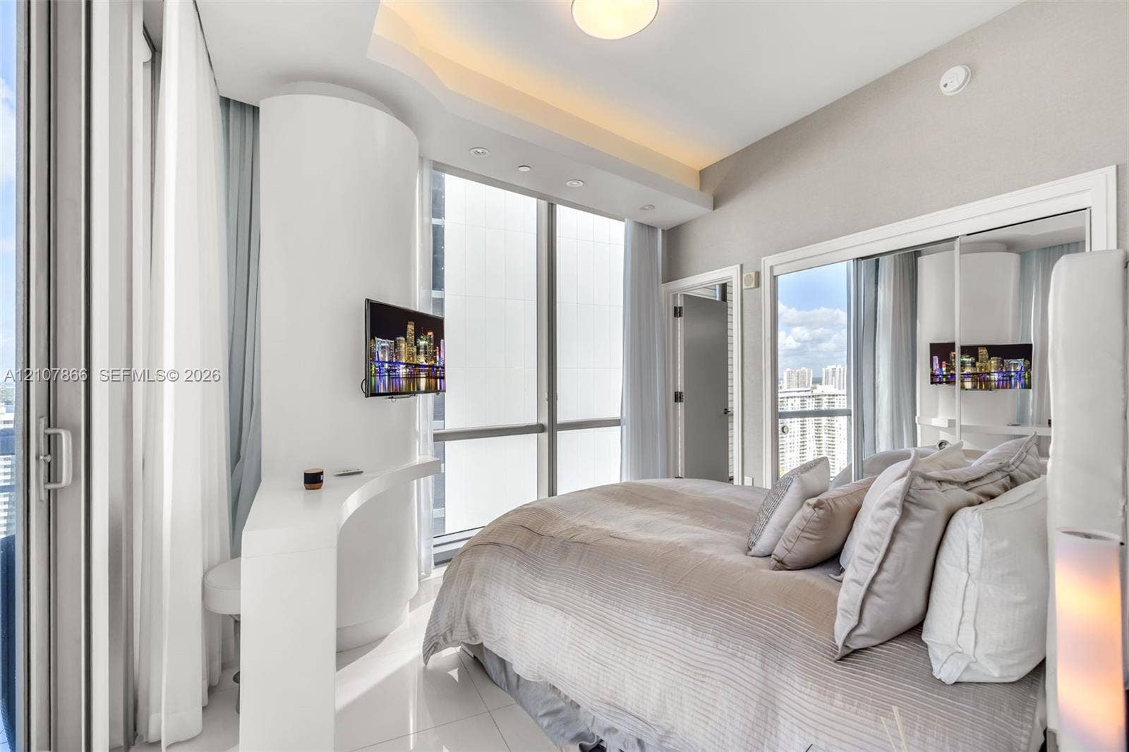 17121 Collins Avenue, #2608, Sunny Isles Beach, FL 33160 Floor-to-ceiling windows, built-in desk, recessed lighting, and mirrored closet doors