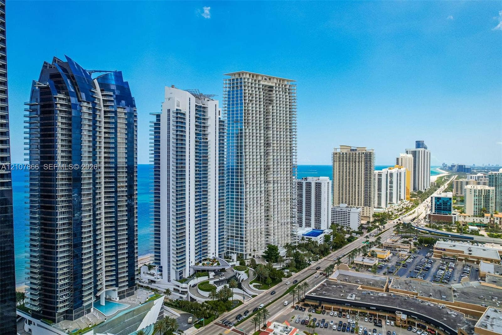 17121 Collins Avenue, #2608, Sunny Isles Beach, FL 33160 High-rise residential architecture featuring glass facades, multiple cantilevered balconies, and a coastal skyline setting