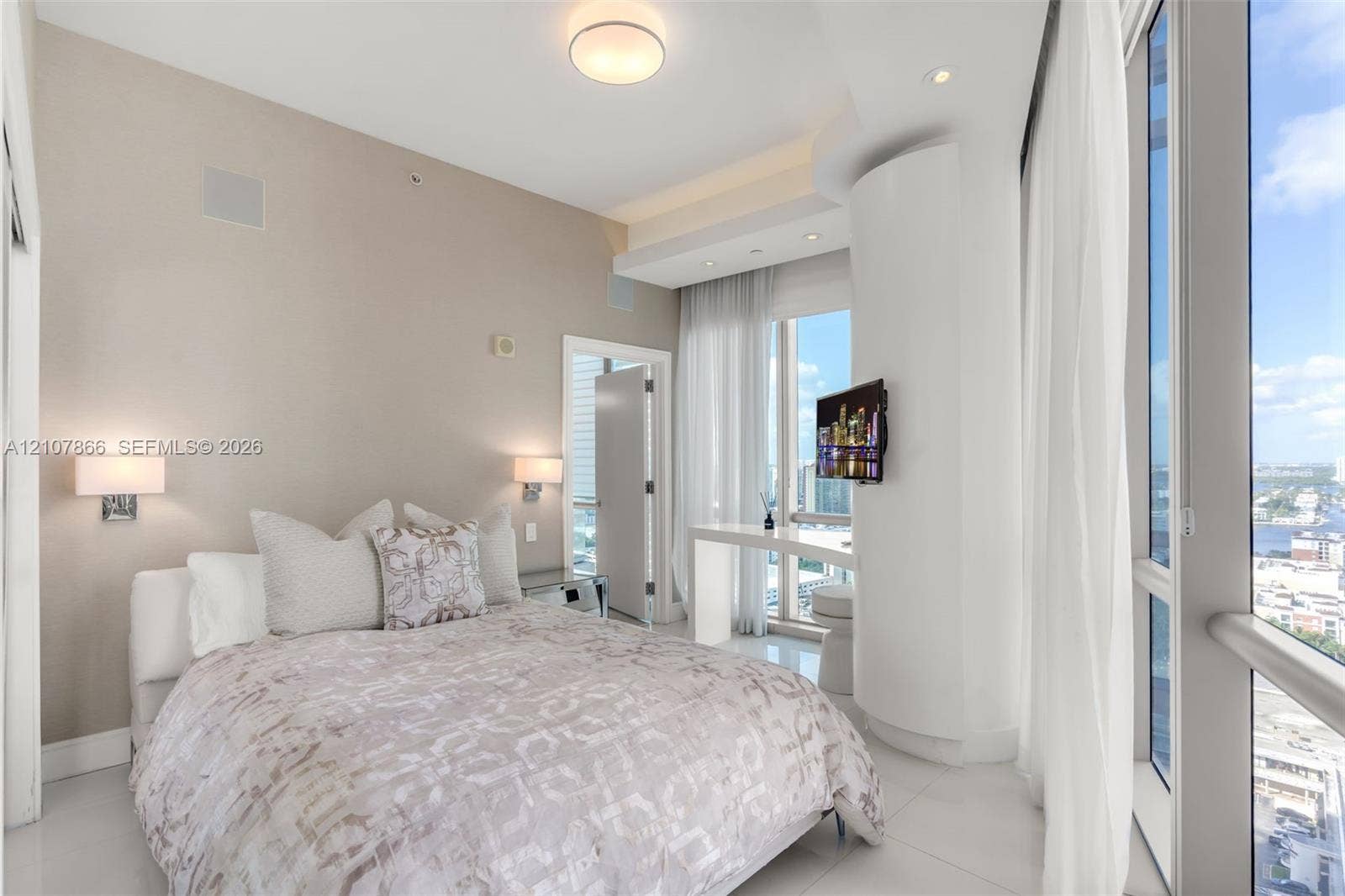 17121 Collins Avenue, #2608, Sunny Isles Beach, FL 33160 Floor-to-ceiling windows, neutral interior wall palette, polished tile flooring, recessed ceiling lighting, and built-in wall-mounted bedside fixtures