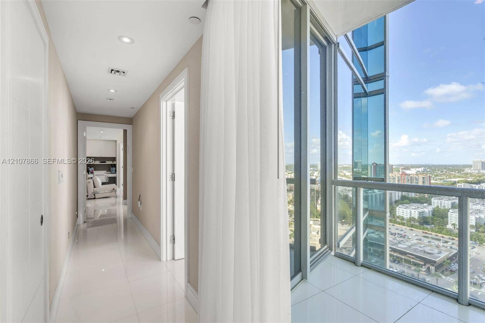 17121 Collins Avenue, #2608, Sunny Isles Beach, FL 33160 Hallway featuring large-format tile flooring, recessed lighting, and floor-to-ceiling glass paneling with metal framing