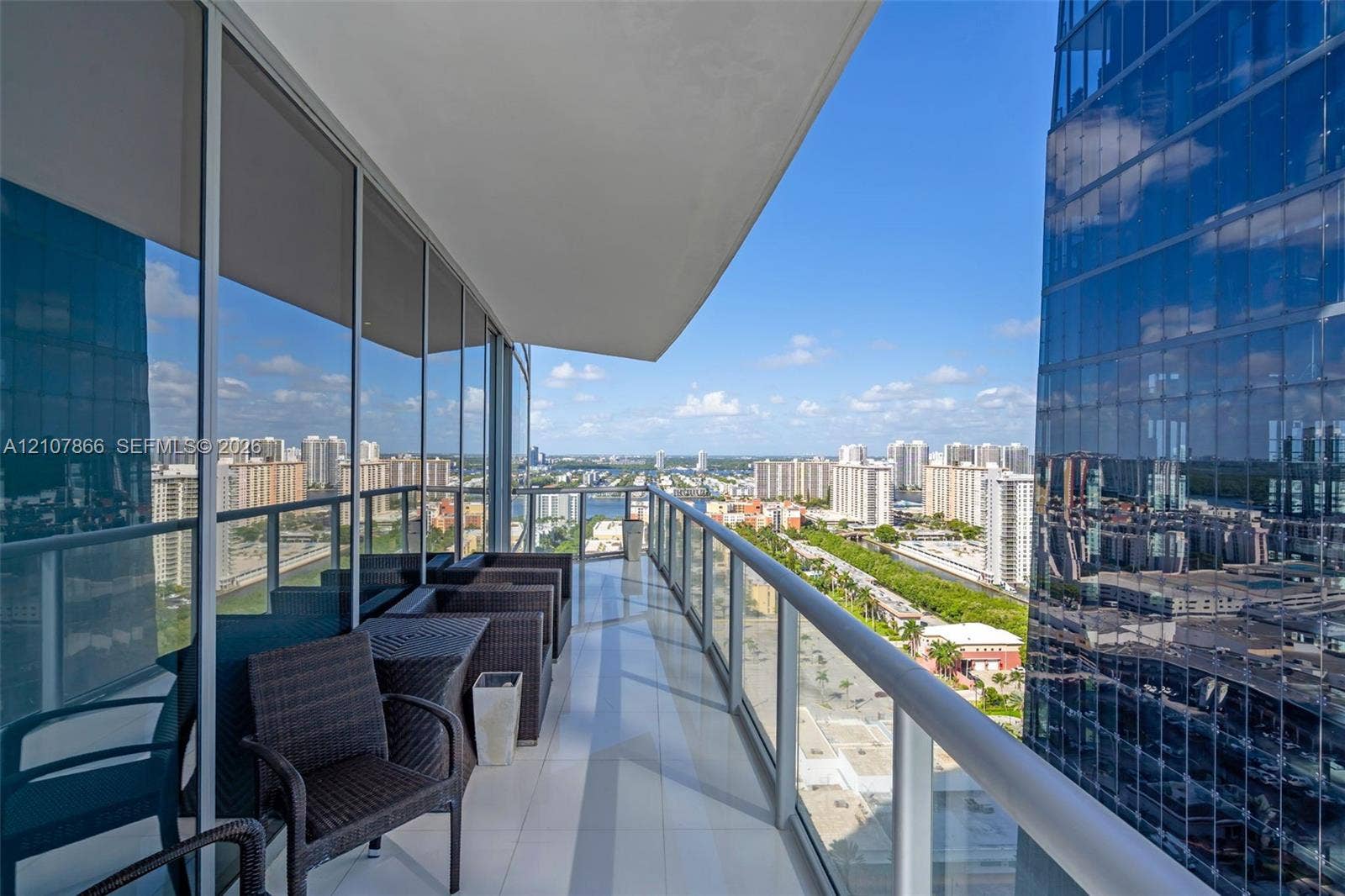 17121 Collins Avenue, #2608, Sunny Isles Beach, FL 33160 Covered balcony with floor-to-ceiling glass paneling and a metal railing