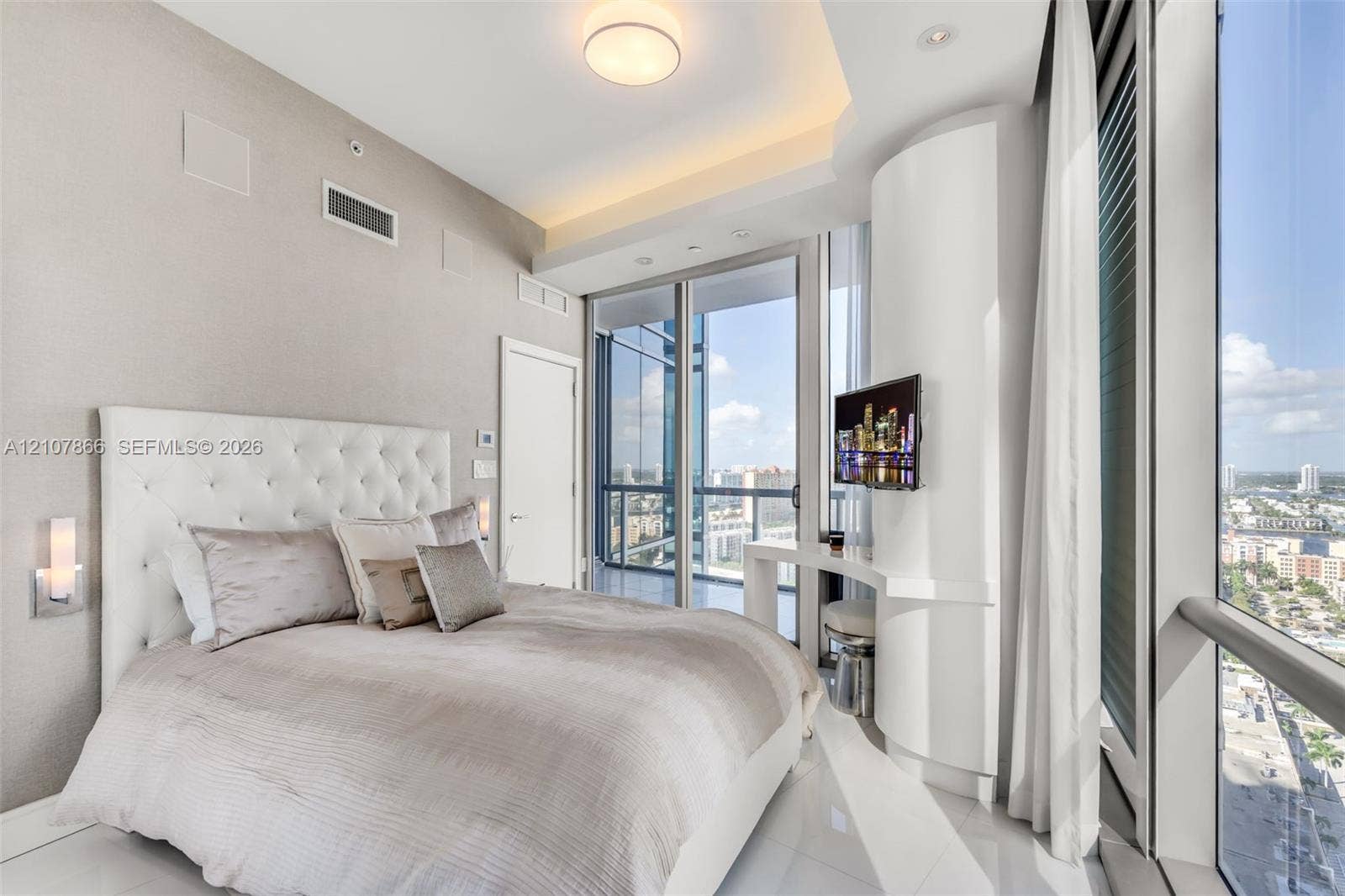 17121 Collins Avenue, #2608, Sunny Isles Beach, FL 33160 Floor-to-ceiling glass windows, recessed ceiling lighting with crown molding, custom curved built-in cabinetry, and tile flooring