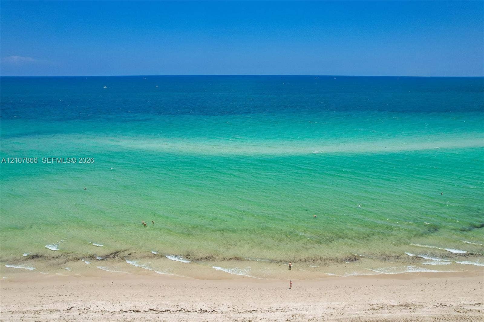 17121 Collins Avenue, #2608, Sunny Isles Beach, FL 33160 Direct oceanfront access featuring a sandy beach, clear turquoise water, and an expansive horizon
