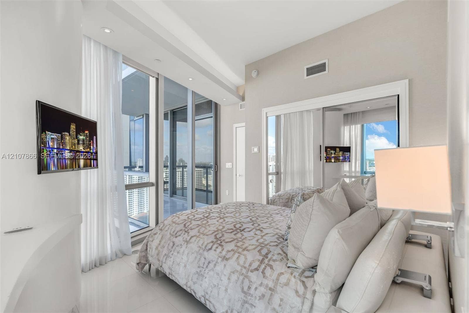 17121 Collins Avenue, #2608, Sunny Isles Beach, FL 33160 Floor-to-ceiling glass windows, recessed ceiling lighting, sliding glass door, and mirrored closet doors