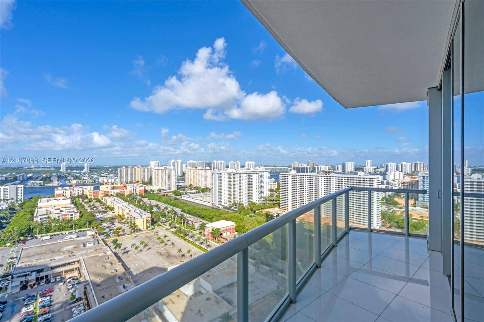 17121 Collins Avenue, #2608, Sunny Isles Beach, FL 33160 Covered balcony featuring glass paneled railings and large-format tile flooring