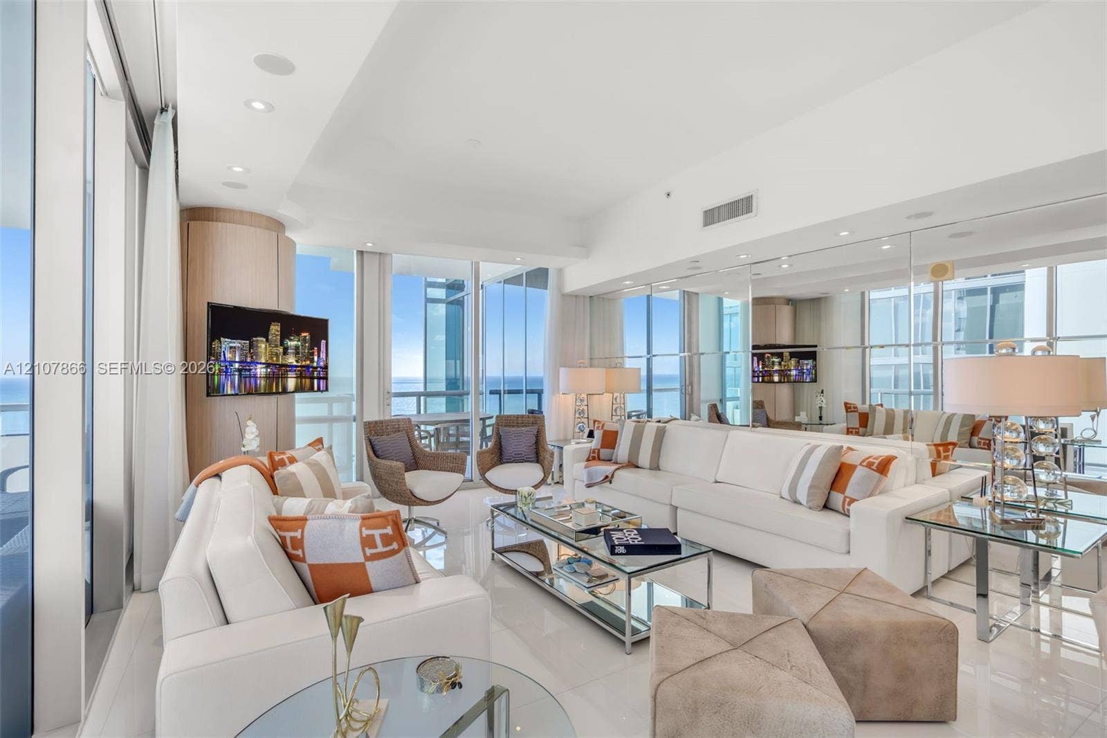 17121 Collins Avenue, #2608, Sunny Isles Beach, FL 33160 Floor-to-ceiling glass windows, expansive reflective wall paneling, recessed lighting, and polished stone-finish flooring