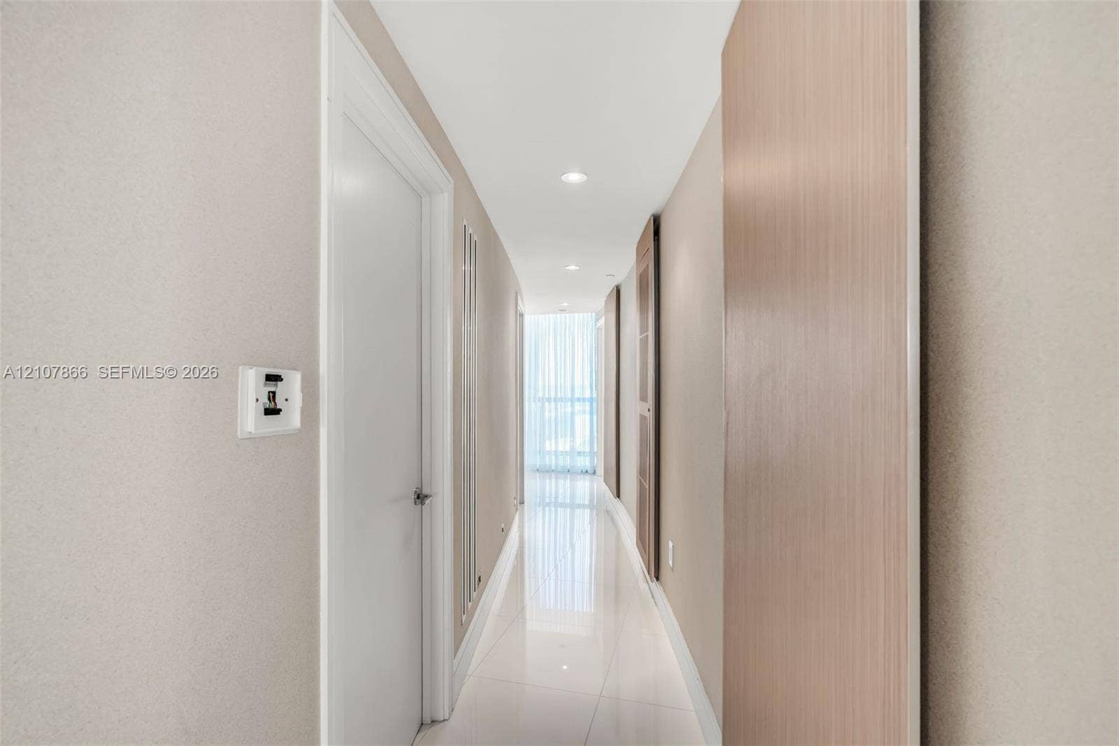 17121 Collins Avenue, #2608, Sunny Isles Beach, FL 33160 Hallway featuring large-format tile flooring, recessed lighting, and light wood-tone door finishes
