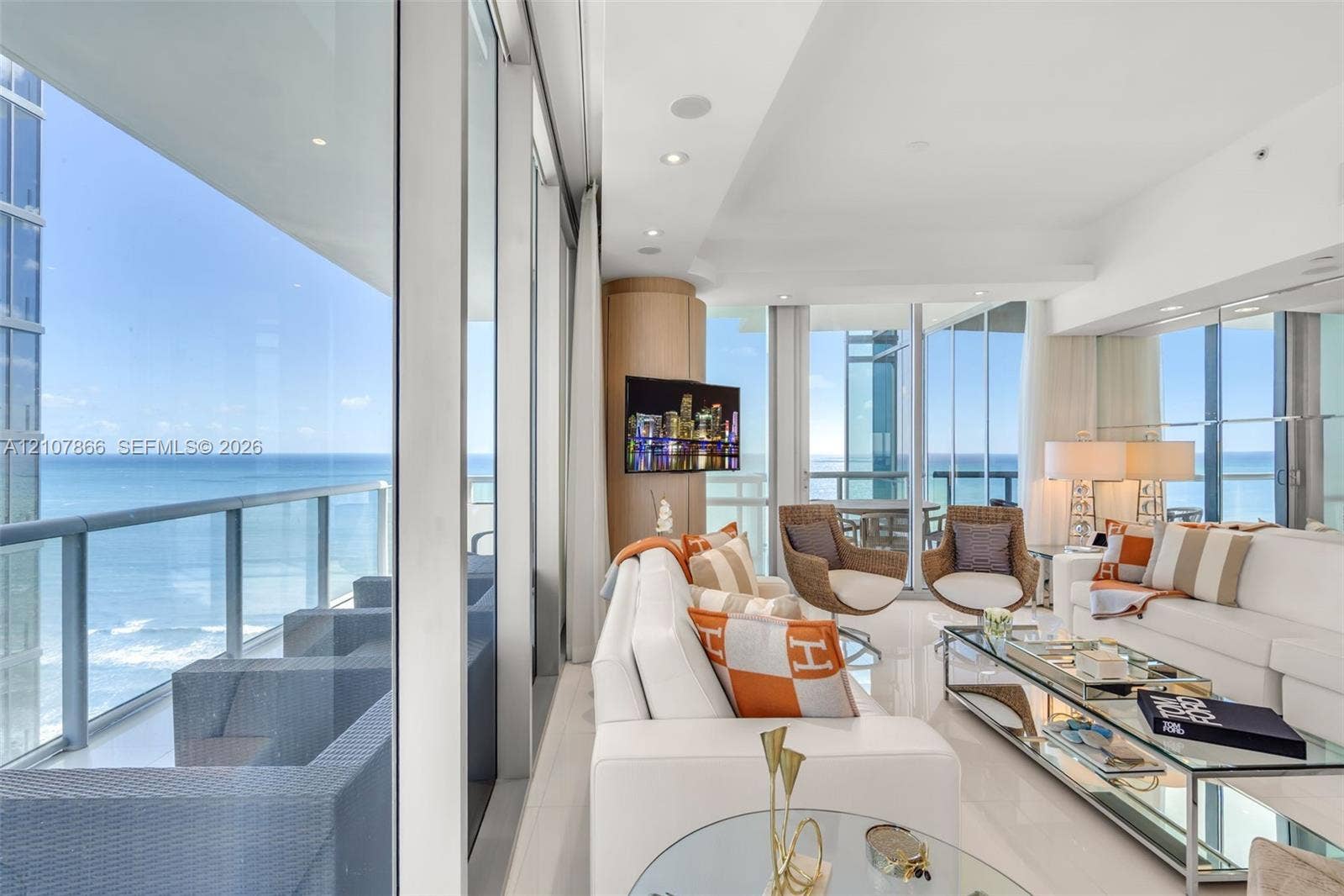 17121 Collins Avenue, #2608, Sunny Isles Beach, FL 33160 Floor-to-ceiling glass walls, expansive private balcony with metal railing, polished stone flooring, recessed ceiling lighting, and built-in rounded cabinetry