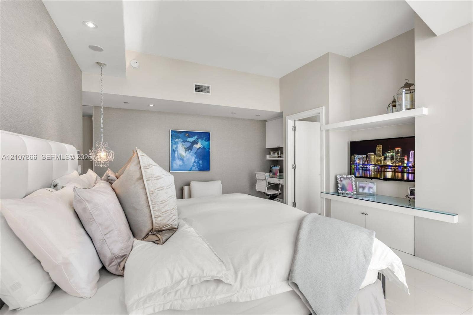 17121 Collins Avenue, #2608, Sunny Isles Beach, FL 33160 Built-in media console with glass shelving, integrated desk area, recessed lighting, and decorative pendant fixture