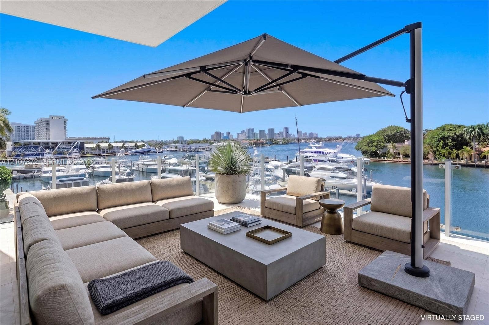 2221 SE 17th Street, #301, Fort Lauderdale, FL 33316 Expansive outdoor terrace featuring light-toned stone tile flooring and a glass panel railing