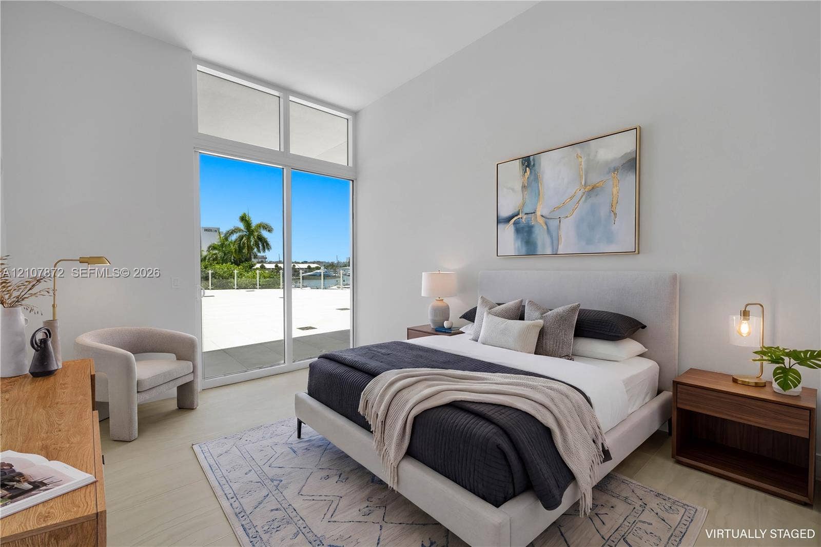2221 SE 17th Street, #301, Fort Lauderdale, FL 33316 High-ceilinged room featuring wood-finish flooring, floor-to-ceiling glass paneling, and an expansive exterior terrace