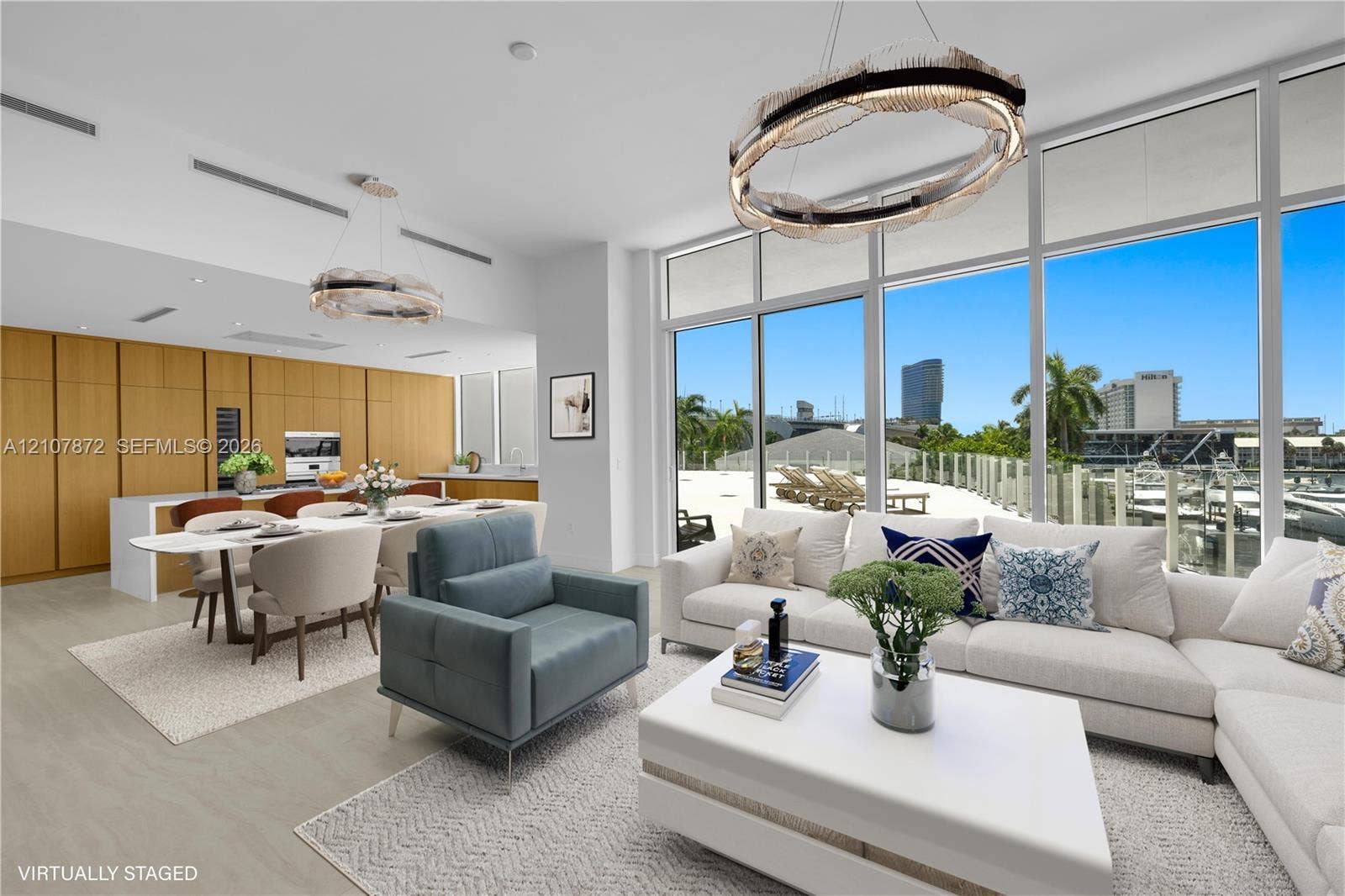 2221 SE 17th Street, #301, Fort Lauderdale, FL 33316 Floor-to-ceiling glass windows, floor-to-ceiling wood-finish cabinetry, built-in kitchen appliances, and geometric modern light fixtures