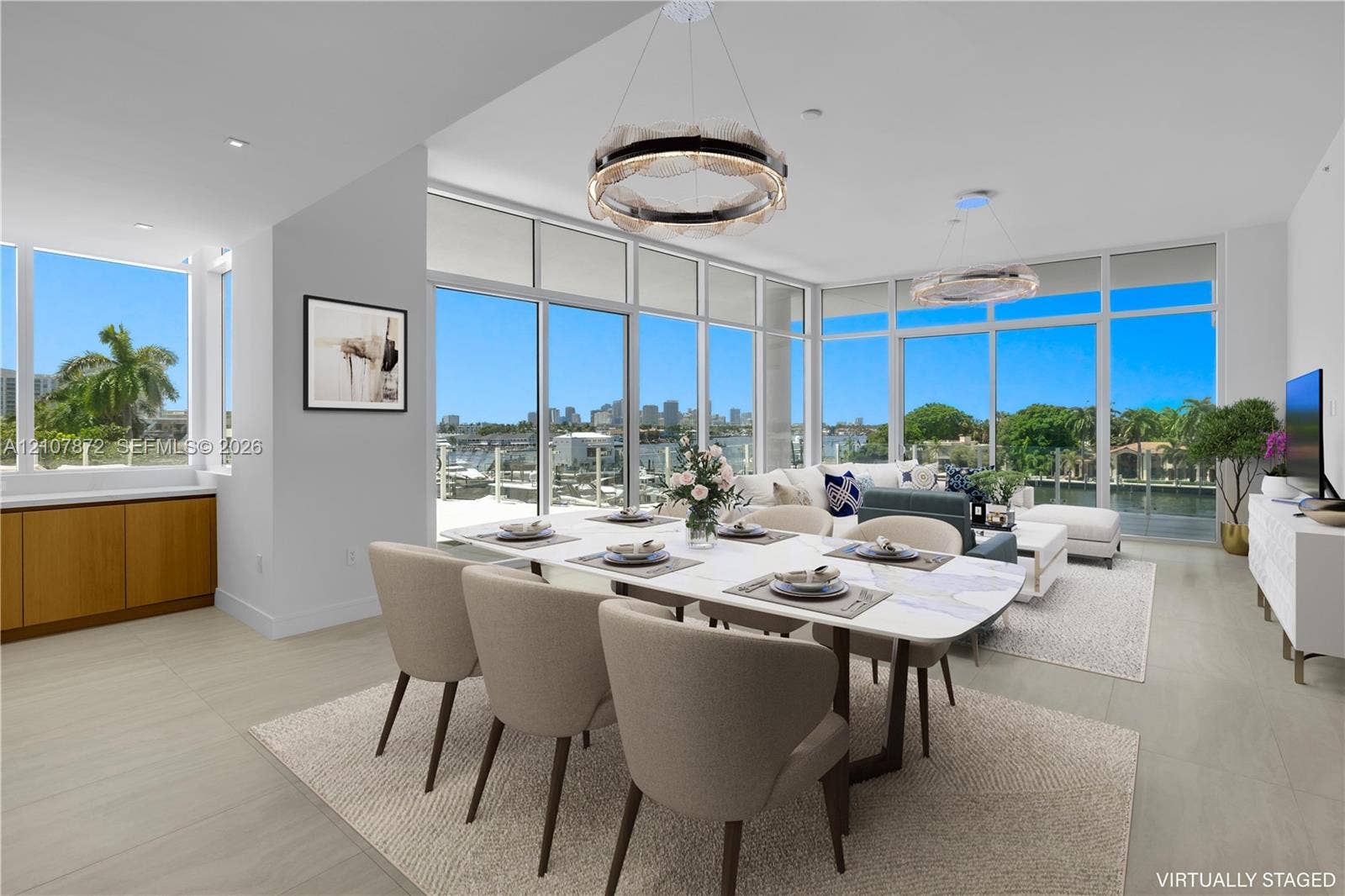 2221 SE 17th Street, #301, Fort Lauderdale, FL 33316 Open-concept living space featuring floor-to-ceiling windows, porcelain tile flooring, built-in lower cabinetry with wood finish, and recessed lighting