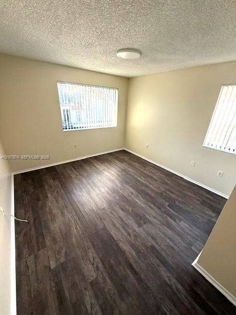 8402 Coral Lake Way, #8402, Coral Springs, Coral Springs, FL 33065 Room featuring wood-finish flooring, neutral wall paint, and dual windows with vertical blinds