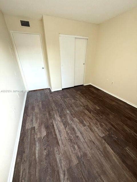 8402 Coral Lake Way, #8402, Coral Springs, Coral Springs, FL 33065 Room featuring wood-finish flooring, neutral wall paint, and a sliding-door closet