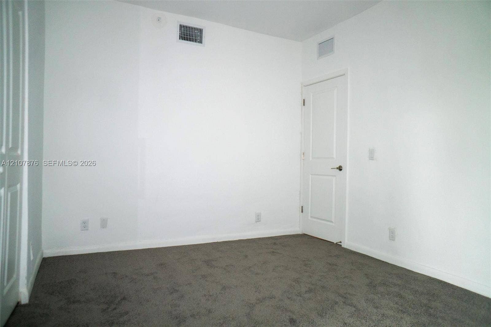 2526 Pierce Street, #8, Hollywood, Hollywood, FL 33020 Neutral-toned carpeted flooring, two-panel interior door, and smooth walls