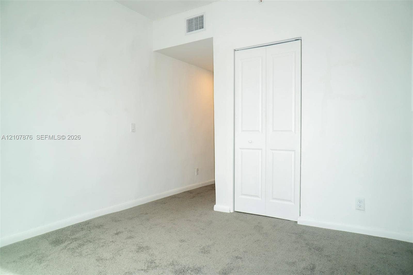 2526 Pierce Street, #8, Hollywood, Hollywood, FL 33020 Neutral-toned carpeting and a closet with white paneled bi-fold doors