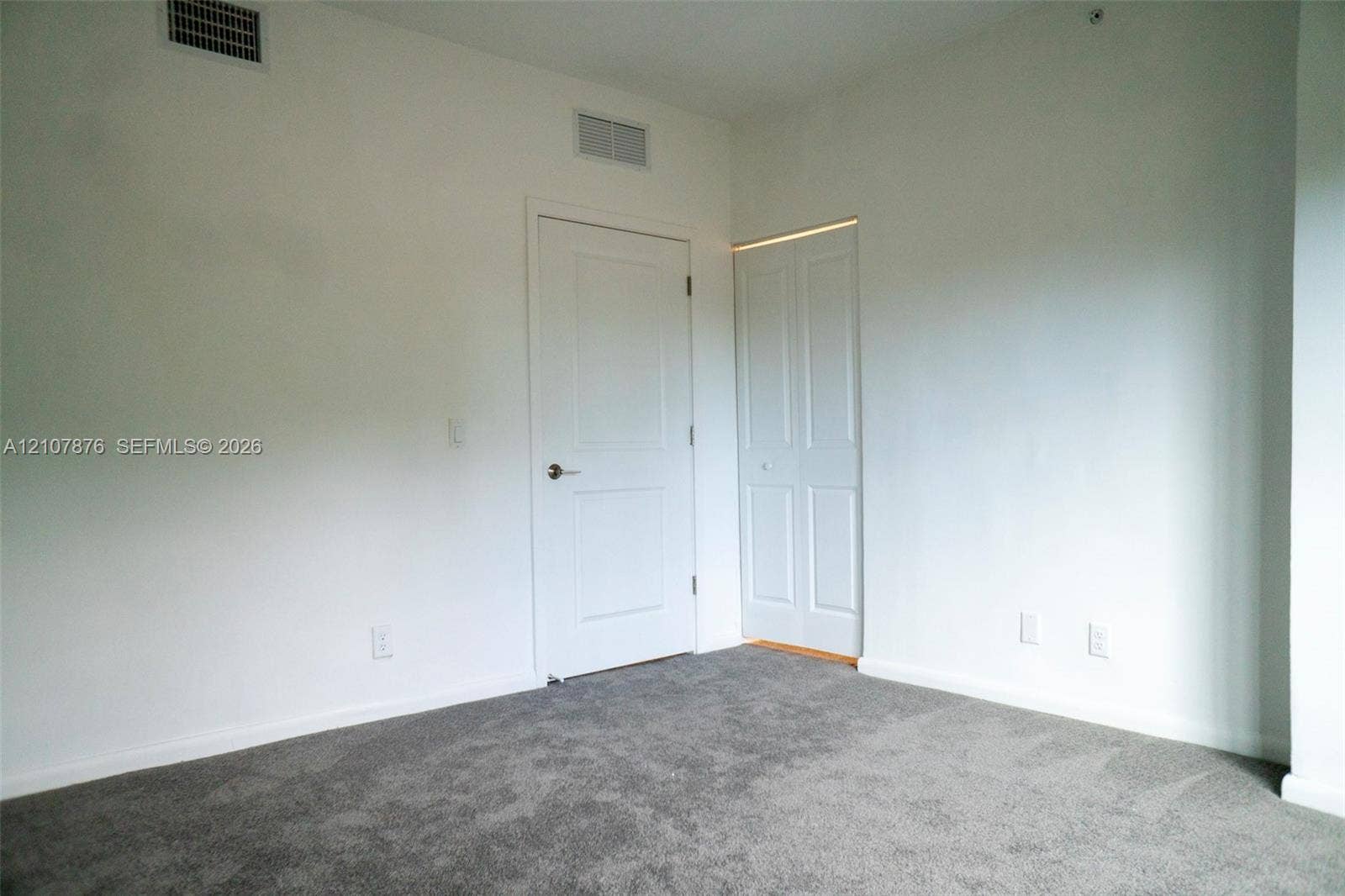 2526 Pierce Street, #8, Hollywood, Hollywood, FL 33020 Neutral-toned wall paint, gray wall-to-wall carpeting, and white interior doors with satin nickel hardware