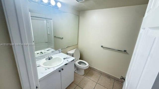 8411 Coral Lake Manor, #8441, Coral Springs, Coral Springs, FL 33065 Bathroom featuring a vanity with a white-veined countertop, integrated oval basin, full-width vanity mirror, tile flooring, and metallic towel bars