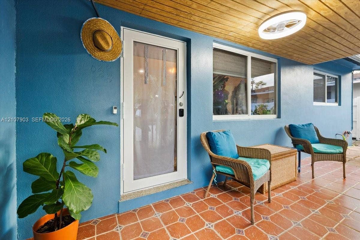 924 SW 15th Terrace, Fort Lauderdale, FL 33312 Covered patio featuring terra cotta tile flooring, wood-plank ceiling, and a full-light glass door