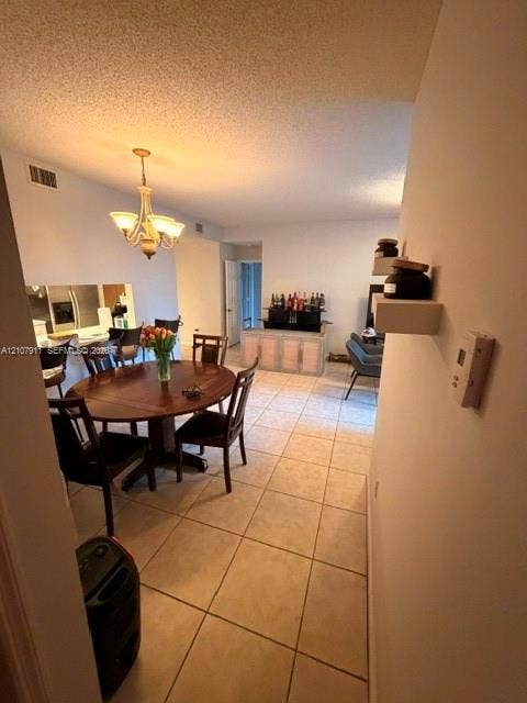 9755 NW 52nd Street, #218, Doral, FL 33178 Ceramic tile flooring, neutral wall finishes, and a traditional five-arm chandelier