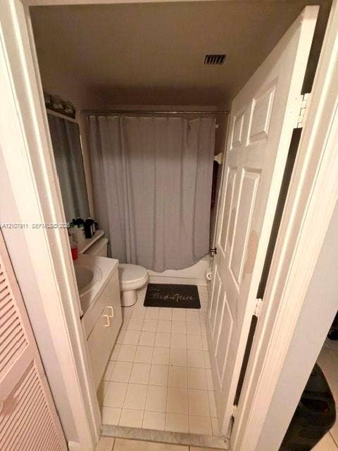 9755 NW 52nd Street, #218, Doral, FL 33178 Bathroom featuring tile flooring, white cabinetry, integrated sink, and a tub-shower combination with a shower rod
