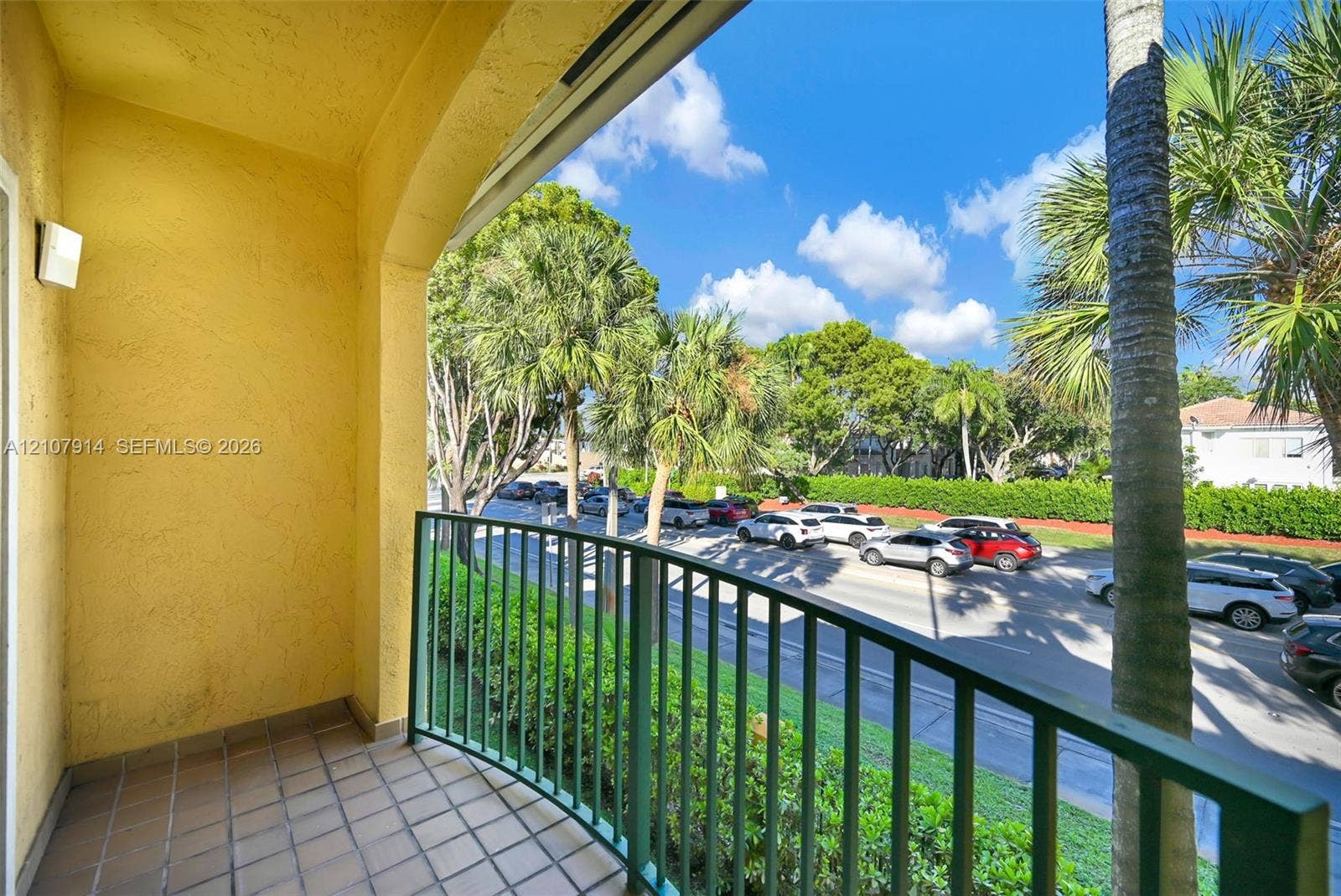 7340 NW 114th Avenue, #205, Doral, FL 33178 Covered balcony featuring tiled flooring, arched architecture, and metal railing