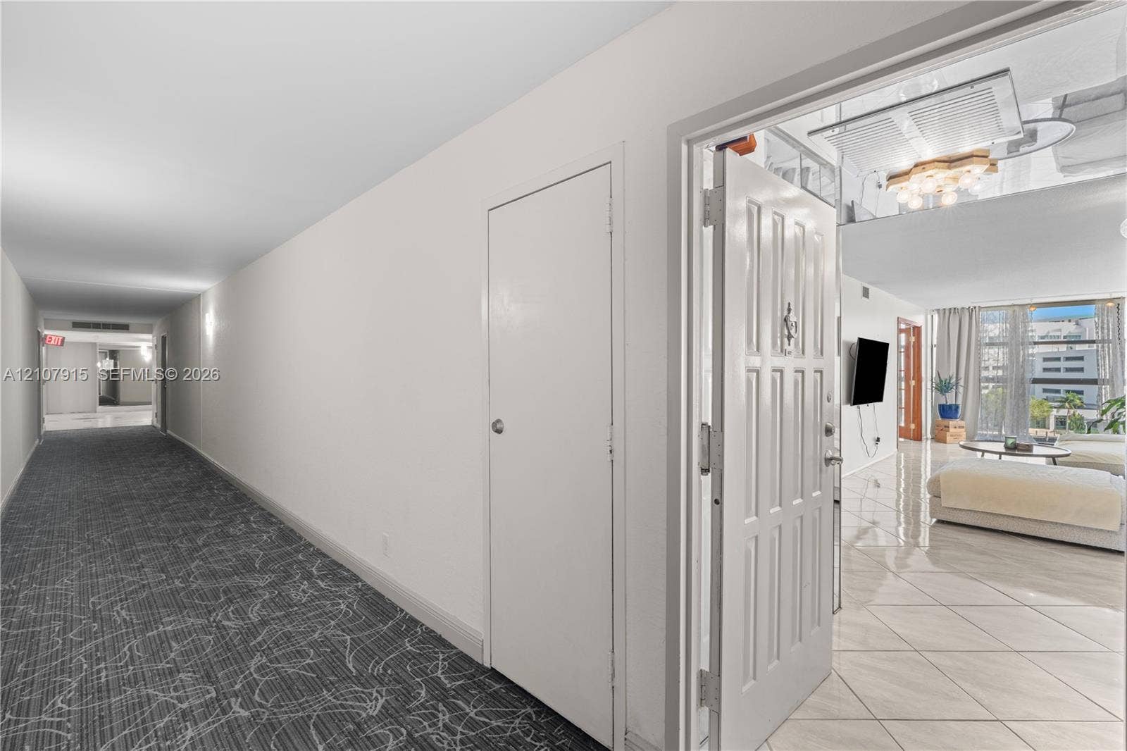 400 Leslie Drive, #622, Hallandale Beach, Hallandale Beach, FL 33009 Entryway featuring a solid panel door, patterned wall-to-wall carpeting, and light-colored tile flooring