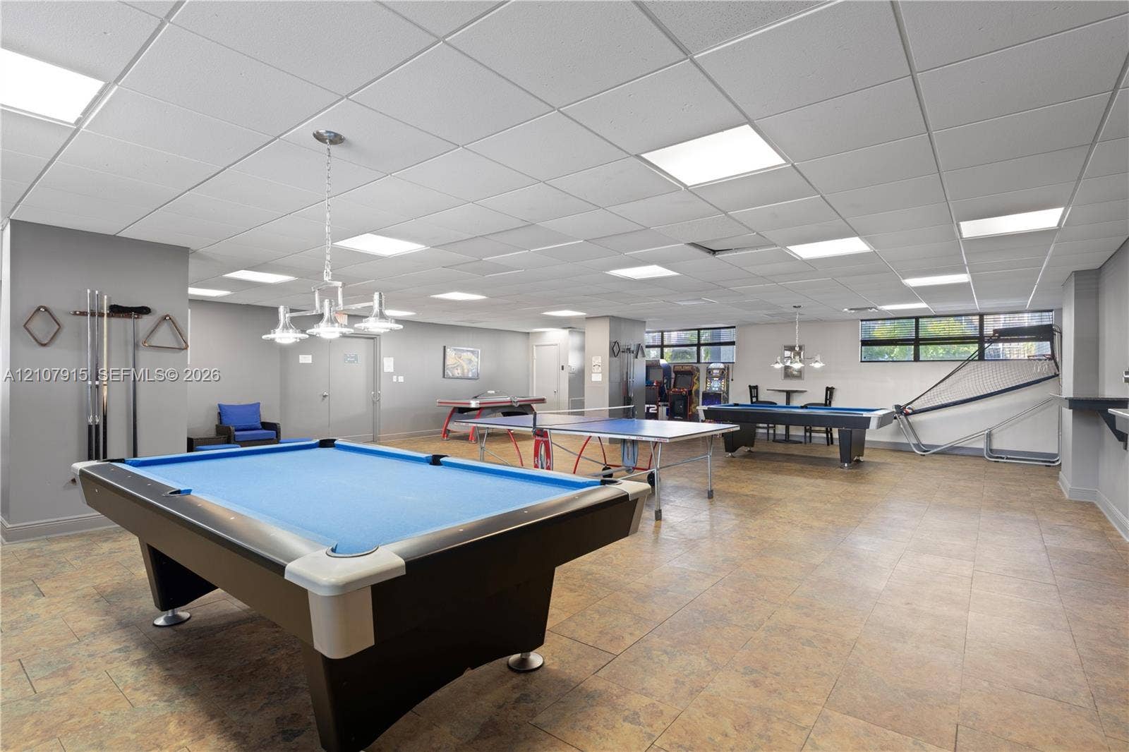 400 Leslie Drive, #622, Hallandale Beach, Hallandale Beach, FL 33009 Expansive recreation area featuring recessed ceiling tile grid, neutral wall finishes, tile flooring, and multi-light hanging fixtures