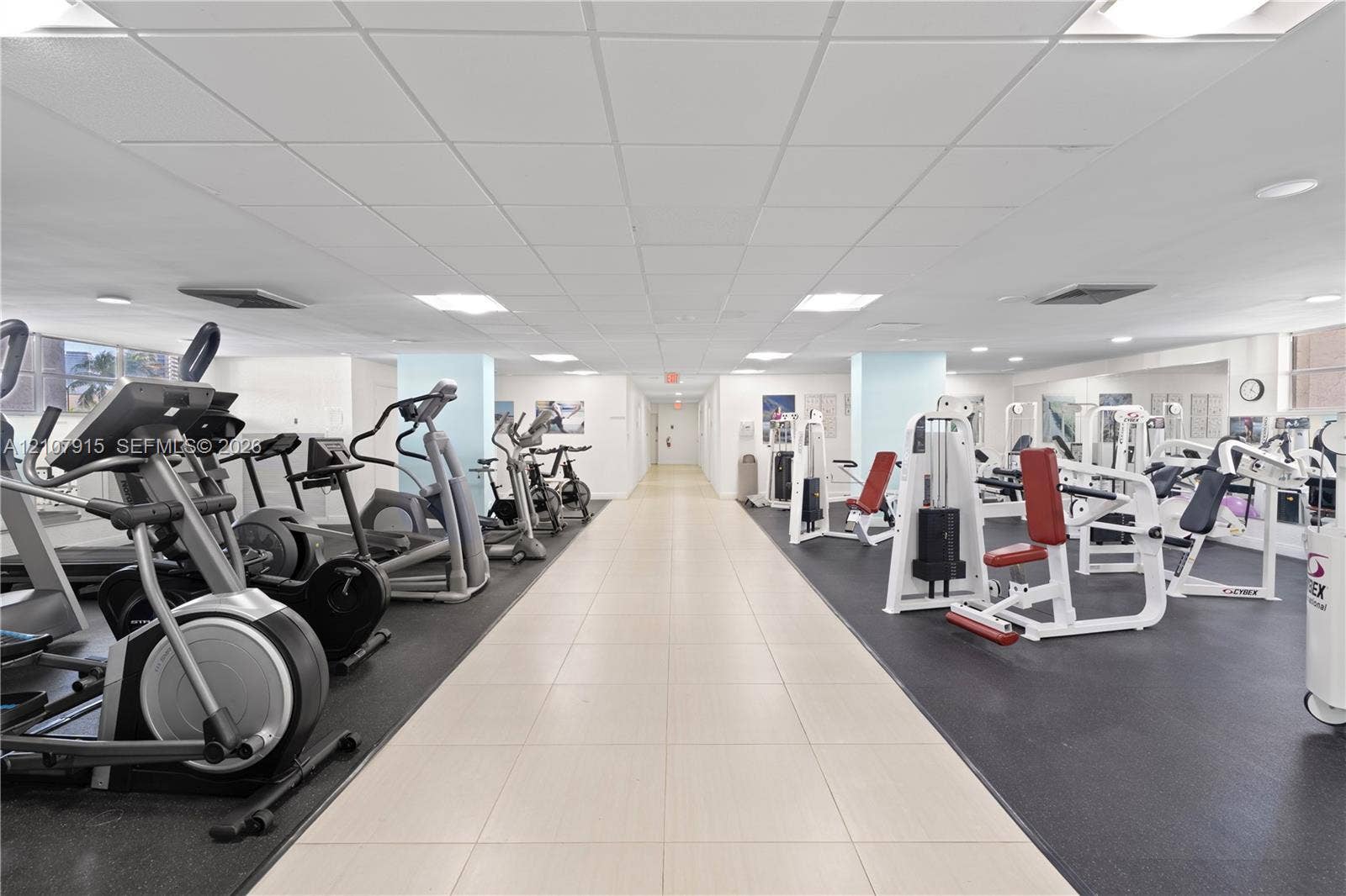 400 Leslie Drive, #622, Hallandale Beach, Hallandale Beach, FL 33009 Fitness center featuring high-contrast rubberized flooring, light-toned ceramic tile pathways, mirrored walls, and recessed grid ceiling lighting