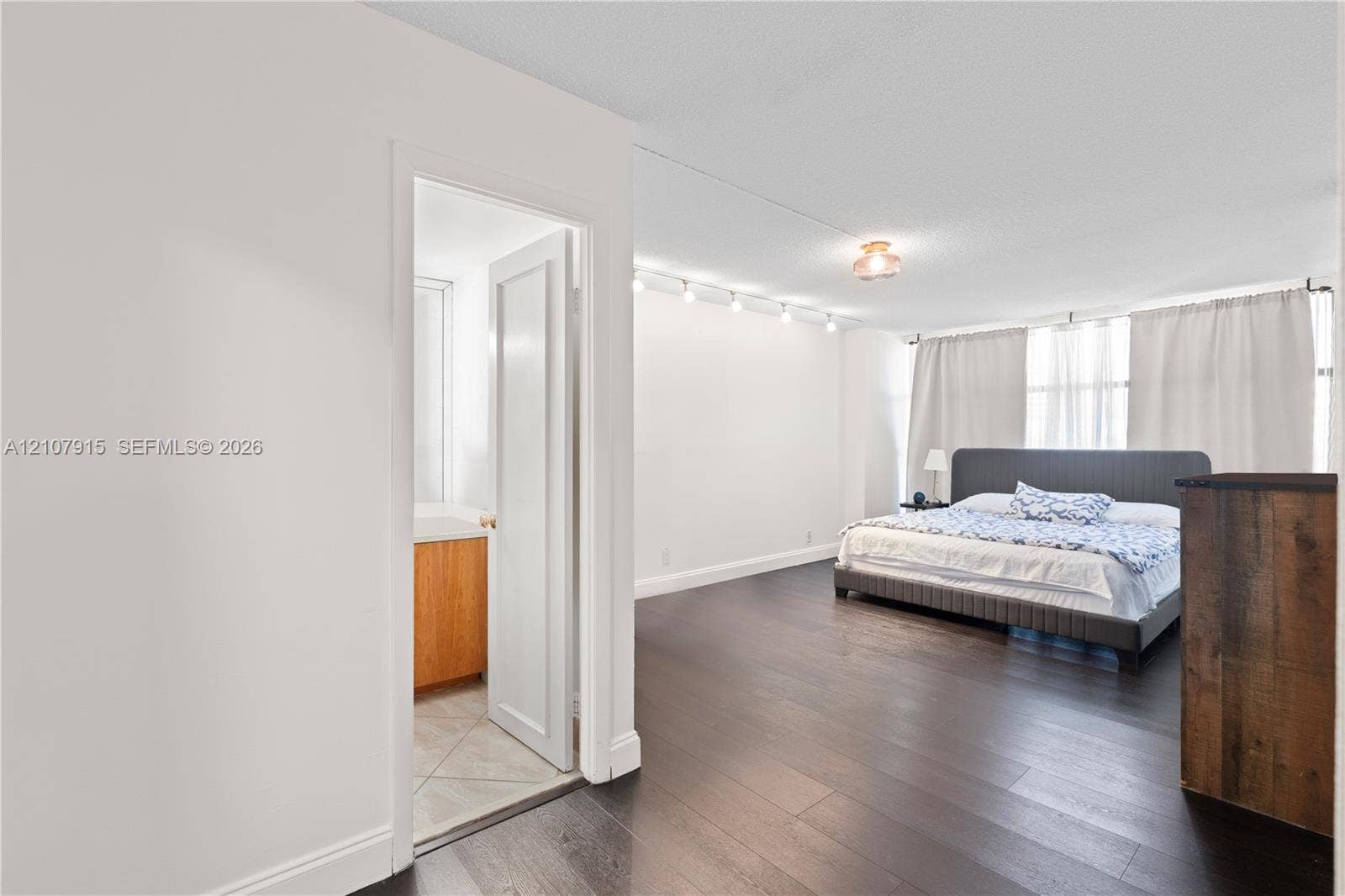 400 Leslie Drive, #622, Hallandale Beach, Hallandale Beach, FL 33009 Dark wood-finish flooring, adjustable track lighting, and a bathroom featuring tile flooring and a light-finish wood vanity