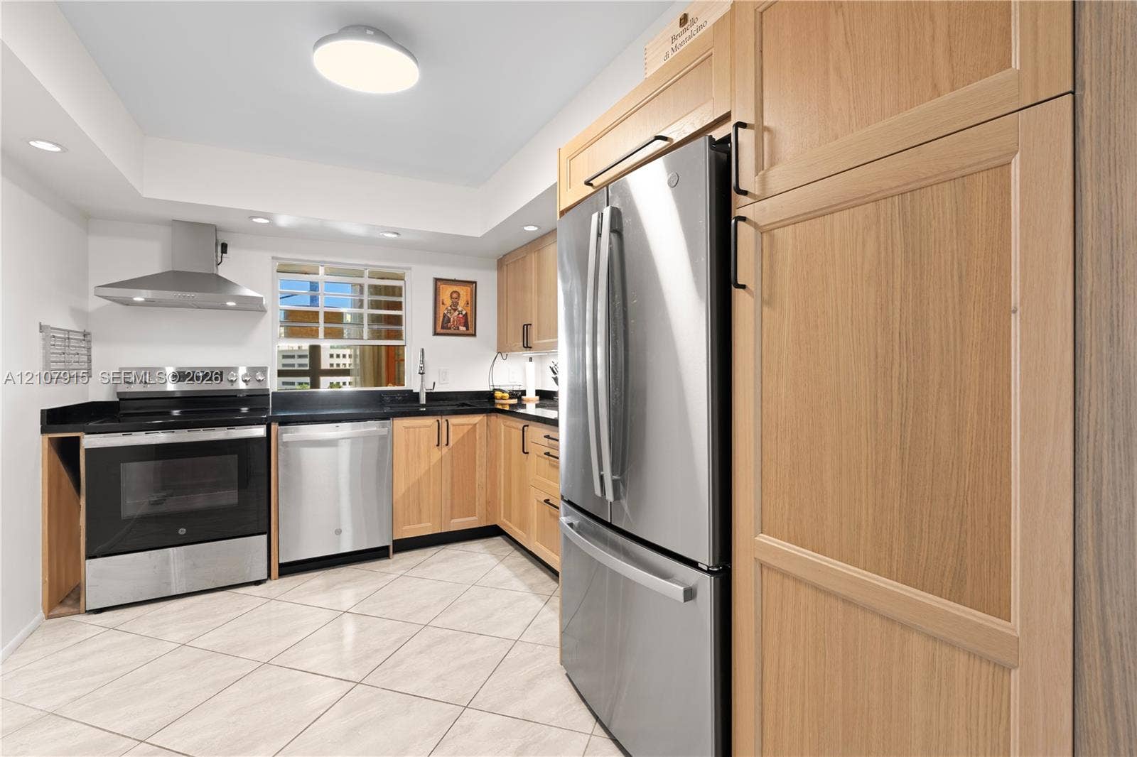 400 Leslie Drive, #622, Hallandale Beach, Hallandale Beach, FL 33009 Kitchen featuring light wood-finish cabinetry, stainless steel appliances, a stainless steel range hood, dark stone countertops, and tile flooring