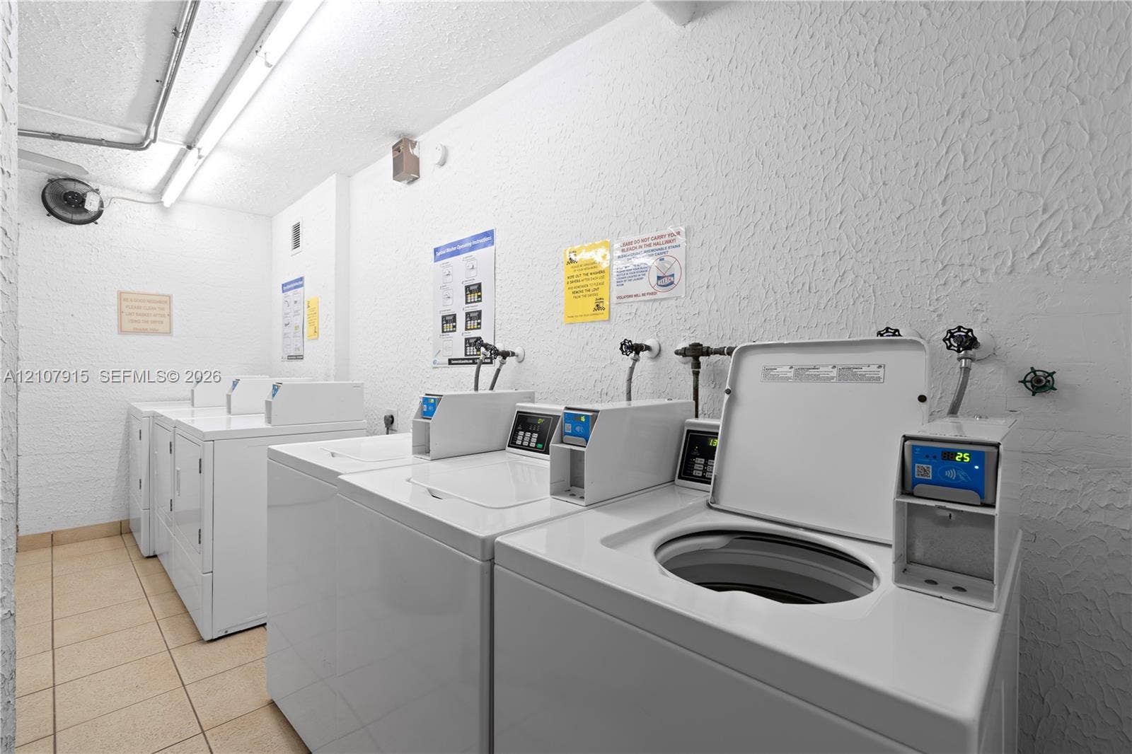 400 Leslie Drive, #622, Hallandale Beach, Hallandale Beach, FL 33009 Laundry room equipped with multiple top-loading washing machines and neutral tile flooring