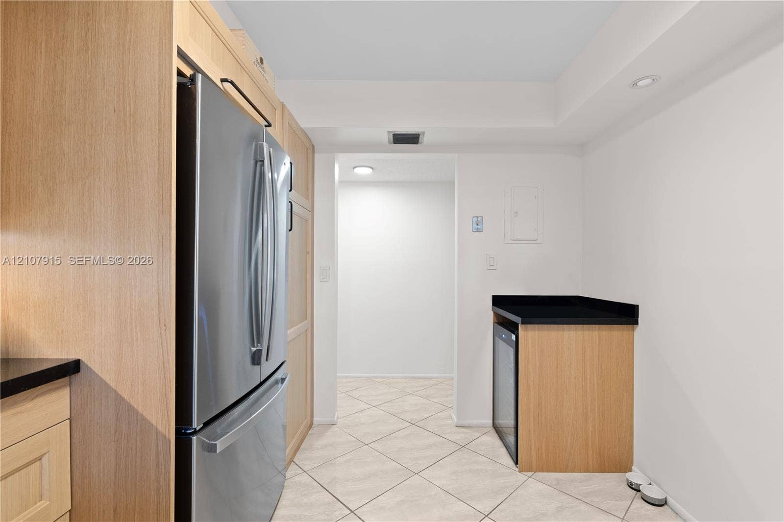 400 Leslie Drive, #622, Hallandale Beach, Hallandale Beach, FL 33009 Kitchen featuring light wood-finish cabinetry, stainless steel French door refrigerator, black countertops, and beverage refrigerator