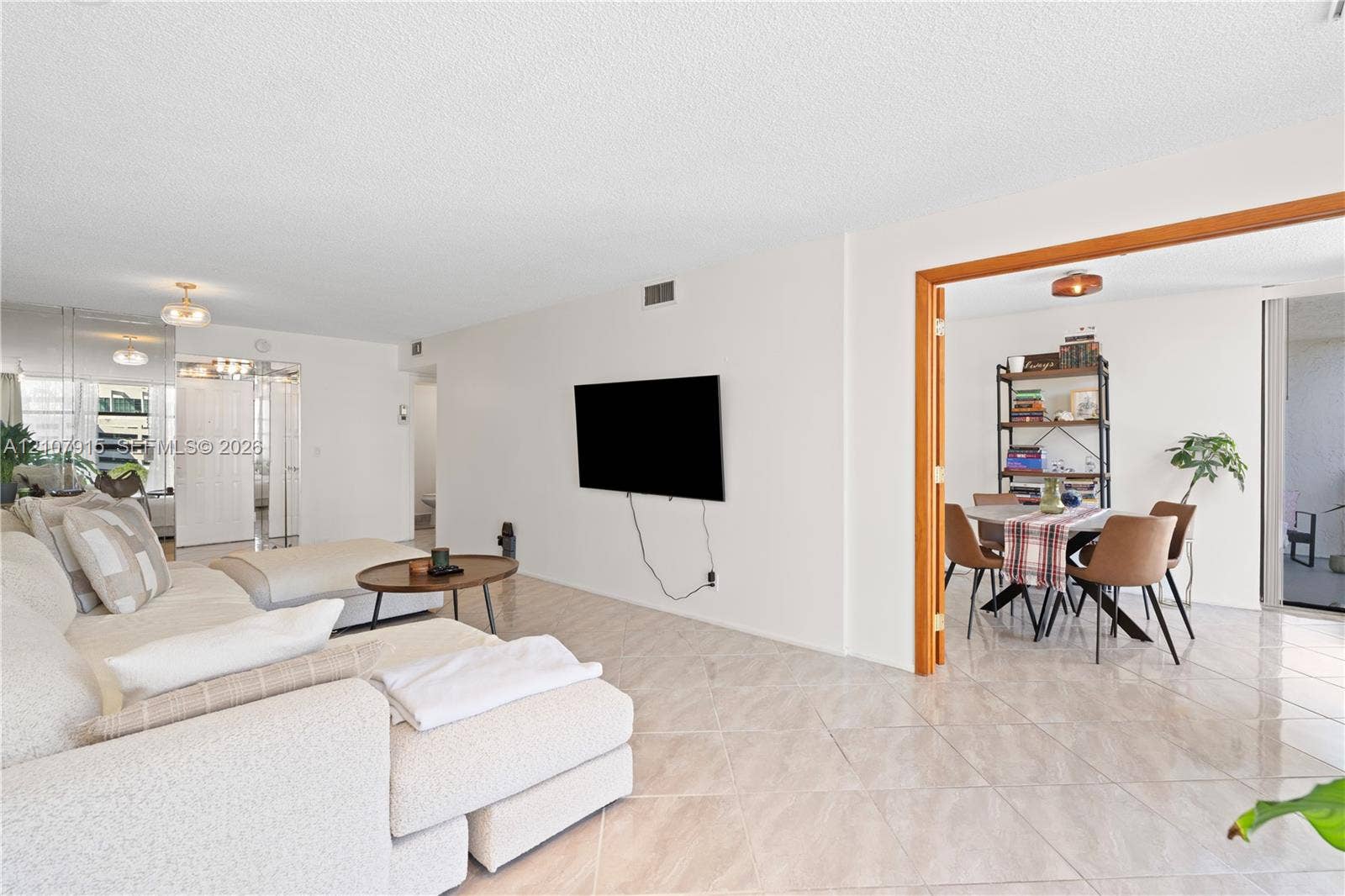 400 Leslie Drive, #622, Hallandale Beach, Hallandale Beach, FL 33009 Open-concept interior featuring light-toned tile flooring, neutral wall finishes, and a wide interior doorway framed with wood trim