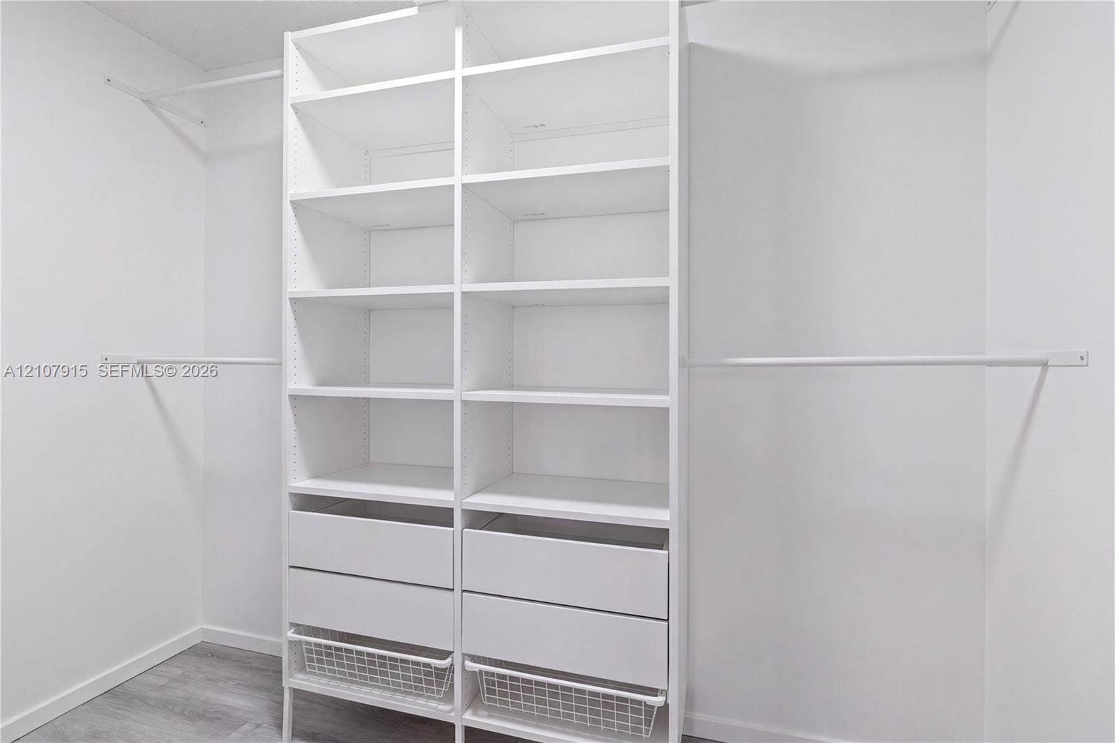 400 Leslie Drive, #622, Hallandale Beach, Hallandale Beach, FL 33009 Custom white built-in shelving unit featuring adjustable storage racks, dual integrated drawers, wire sliding baskets, and dual metal hanging rods