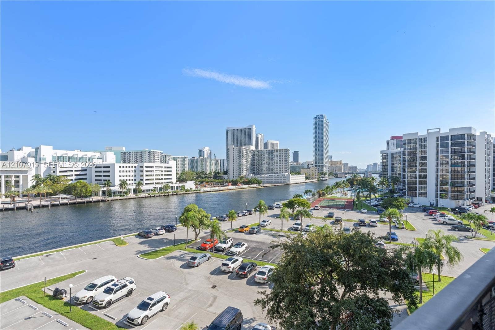 400 Leslie Drive, #622, Hallandale Beach, Hallandale Beach, FL 33009 Elevated perspective featuring a waterfront urban landscape, deep-water canal, mature palm trees, and asphalt surface parking