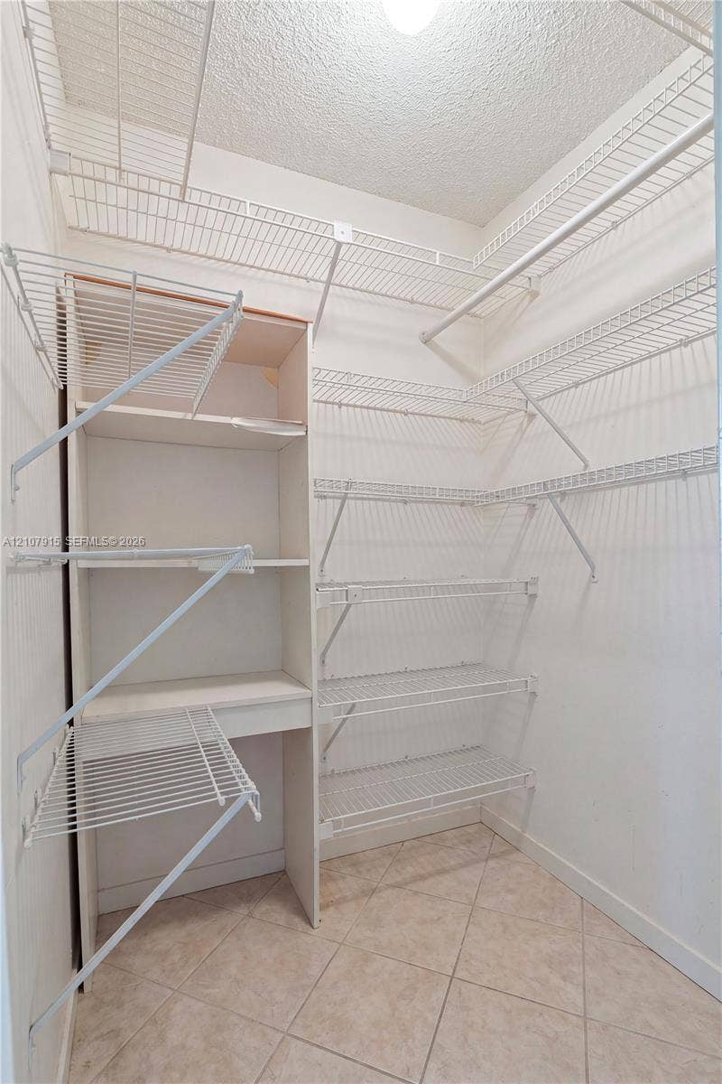 400 Leslie Drive, #622, Hallandale Beach, Hallandale Beach, FL 33009 Storage area featuring built-in vertical shelving, multi-level wire rack organizers, and tile flooring