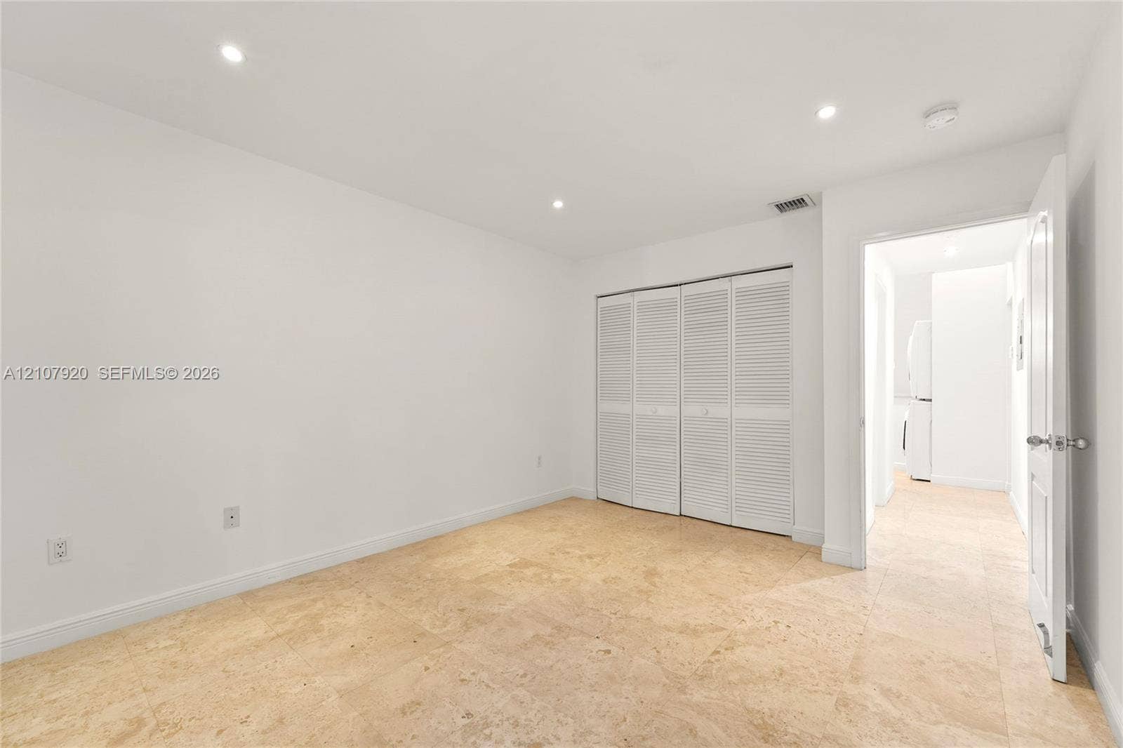 3062 Shipping Avenue, #3062, Miami, Miami, FL 33133 Neutral-toned stone flooring, recessed ceiling lighting, and a multi-panel closet with louvered doors