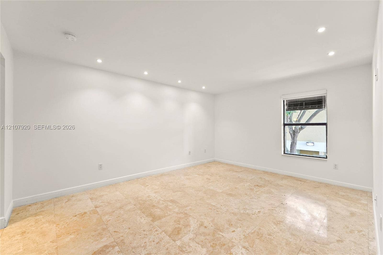 3062 Shipping Avenue, #3062, Miami, Miami, FL 33133 Interior space featuring large-format stone flooring, recessed ceiling lighting, and a single-pane window with integrated blinds