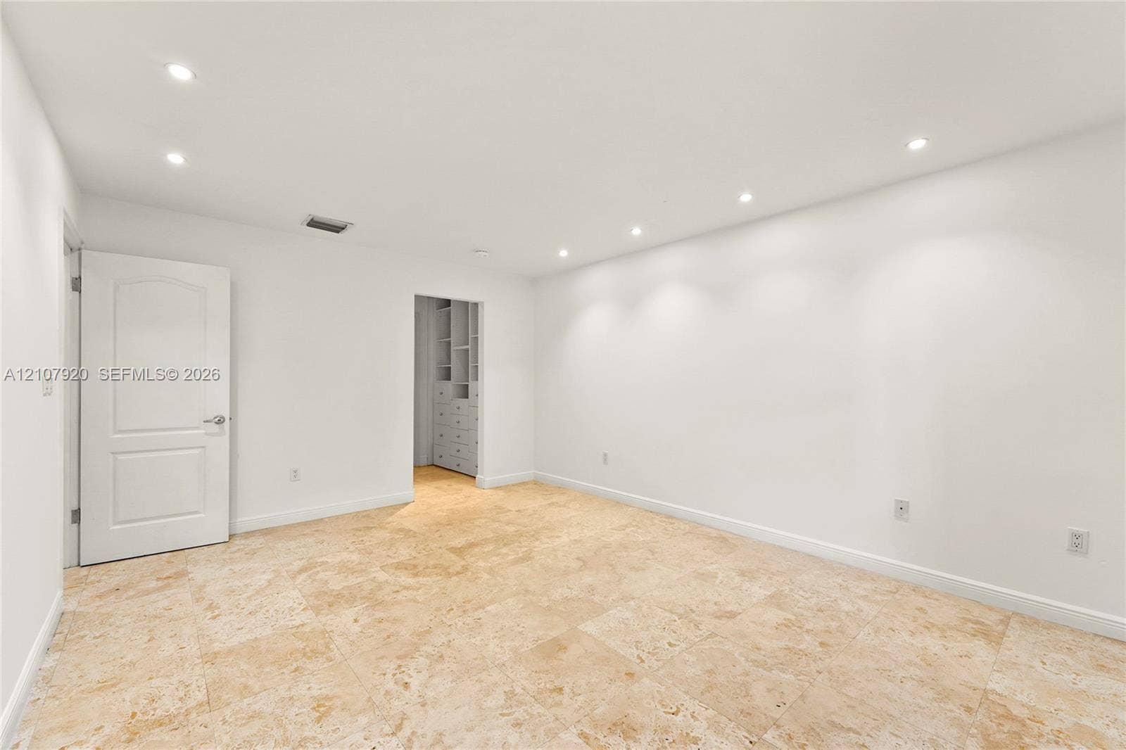 3062 Shipping Avenue, #3062, Miami, Miami, FL 33133 Neutral-toned stone tile flooring, recessed ceiling lighting, and custom built-in cabinetry