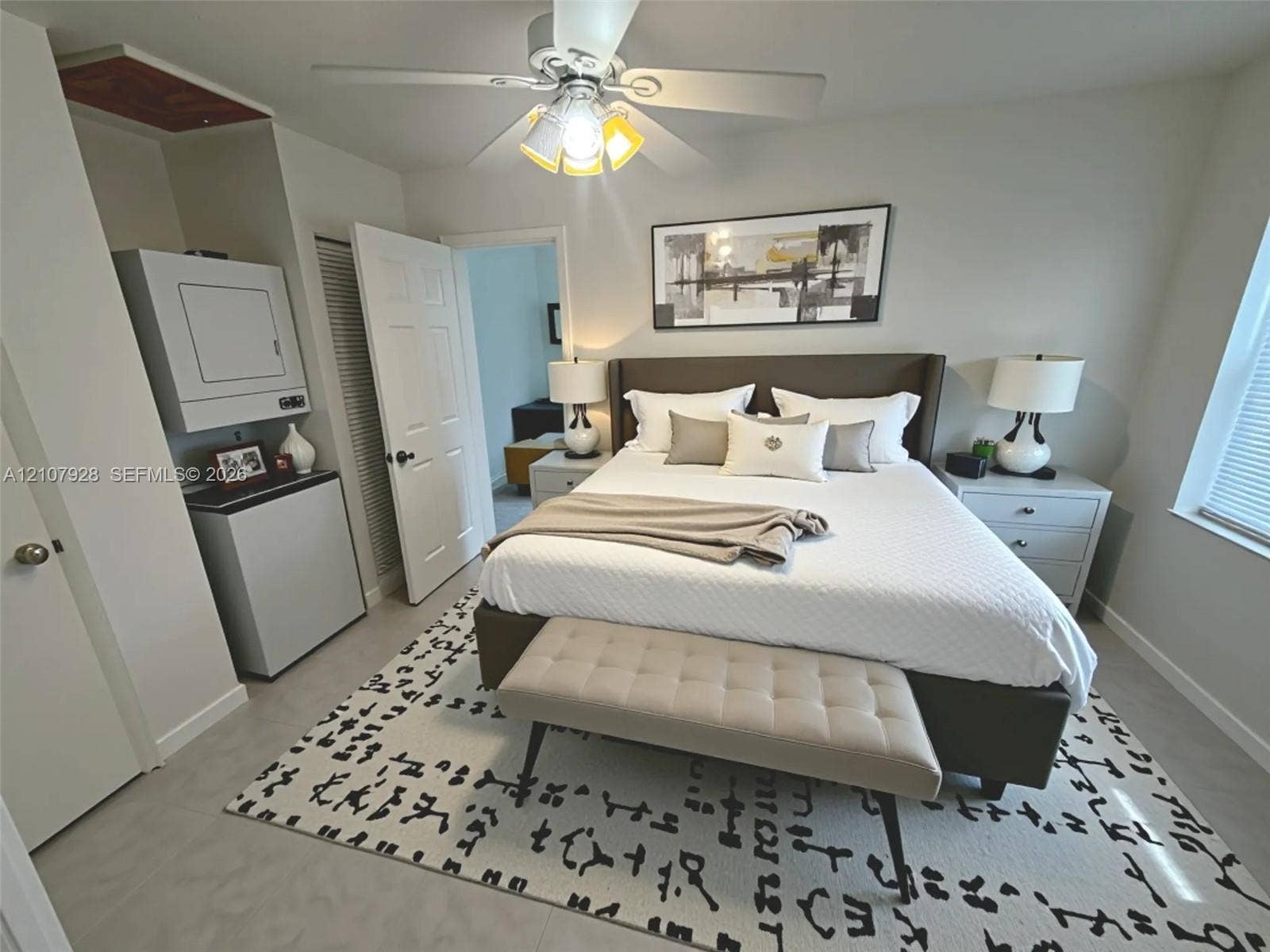 815 Foster Road, #2, Hallandale Beach, Hallandale Beach, FL 33009 Interior room featuring smooth-finish tile flooring, a ceiling fan with integrated lighting, and a built-in wall-mounted laundry appliance setup