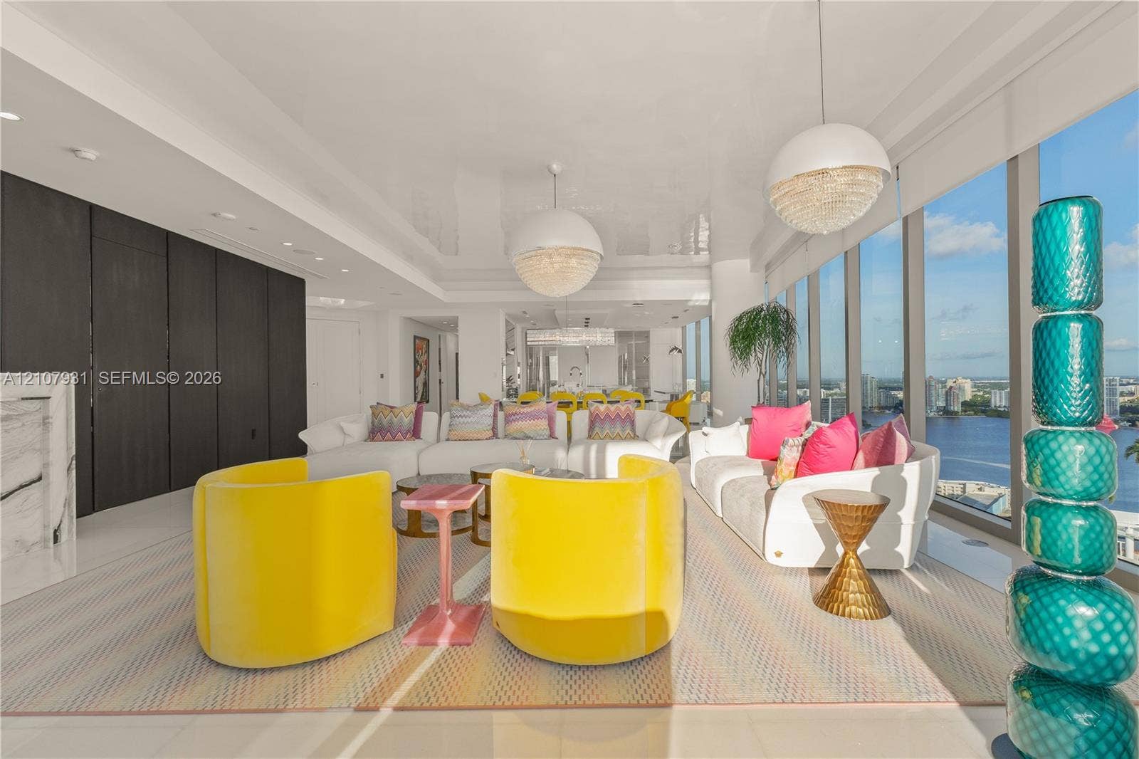 Floor-to-ceiling windows, high-gloss white flooring, recessed ceiling lighting, and dome pendant fixtures