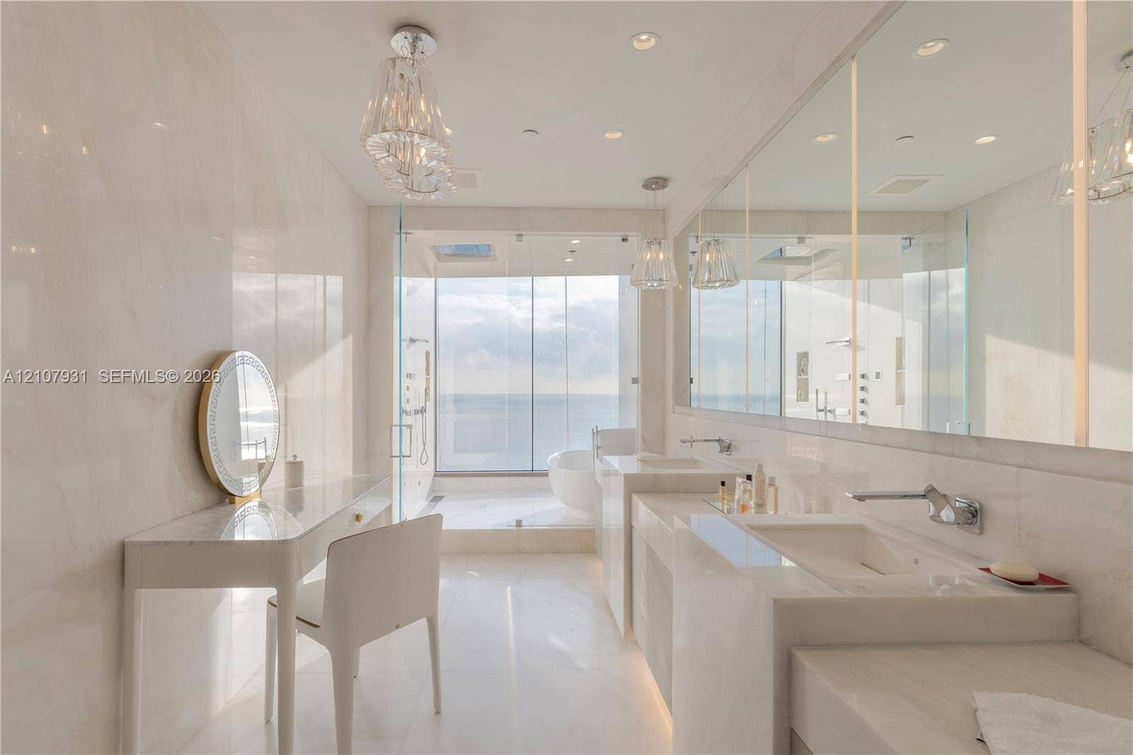 Bathroom featuring floor-to-ceiling stone wall cladding, dual integrated stone sinks, wall-mounted chrome faucets, glass-enclosed shower, and built-in stone vanity