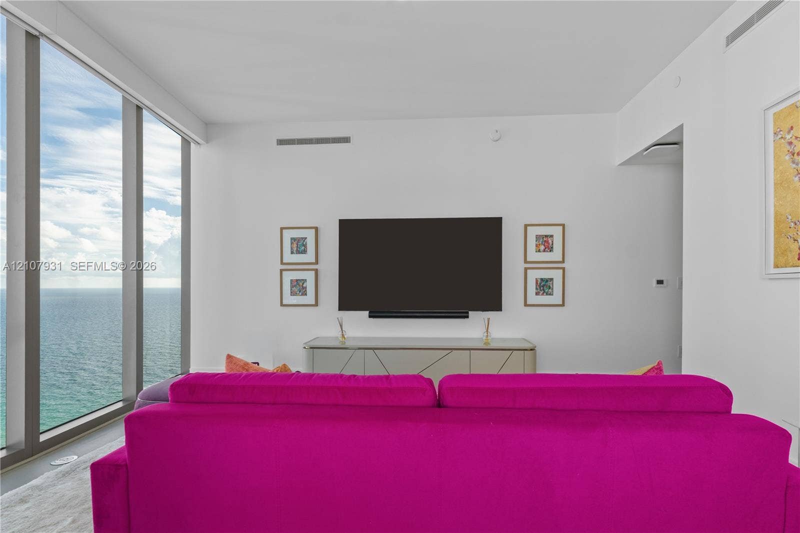 Floor-to-ceiling windows featuring ocean scenery and neutral wall finishes