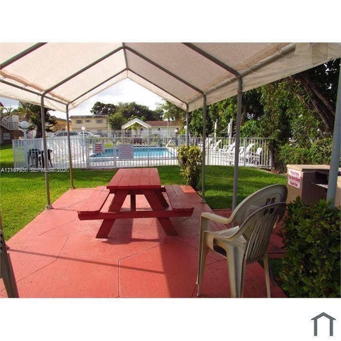 2839 Taylor Street, #3, Hollywood, Hollywood, FL 33020 Covered outdoor patio with stamped concrete flooring, fenced swimming pool, and manicured lawn