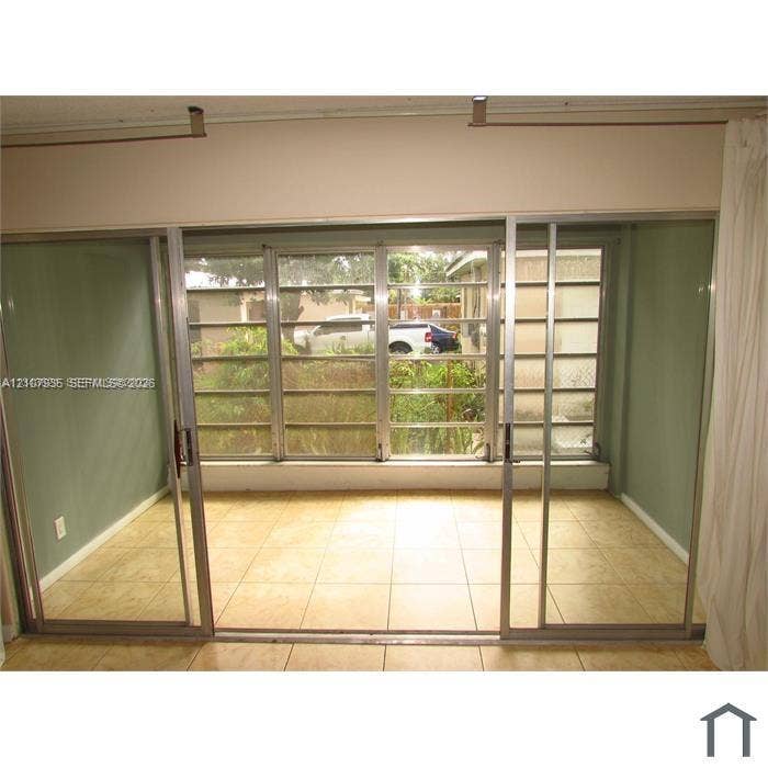2839 Taylor Street, #3, Hollywood, Hollywood, FL 33020 Floor-to-ceiling sliding glass doors with metallic frames and neutral ceramic tile flooring